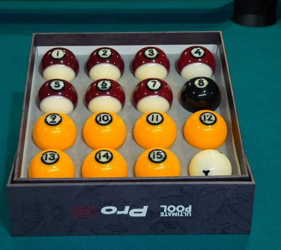 The supplied Ultimate Pool Pro ball set: numbered red and yellow balls, a black 8-ball and a white cue ball